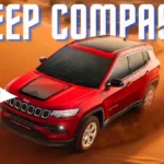 a red car driving through a desert